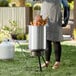 A woman cooking a turkey in a Backyard Pro turkey fryer kit.