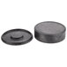 A close-up of a black circular polyethylene tortilla server with a spiral lid.
