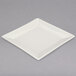 A white square Homer Laughlin china plate with a small rim.