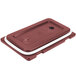 A brick red plastic lid for a Cambro Camtainer with a white rectangular strip.