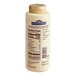A white bottle of Ghirardelli White Chocolate Flavoring Sauce with a brown cap.