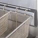 The stainless steel basket of a Vulcan PowerFry3 gas floor fryer.