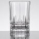 A clear Spiegelau Perfect Serve Longdrink/Collins glass with a curved edge.