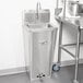 A Regency stainless steel pedestal base for a sink.