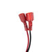 A close-up of a red and black electrical wire next to a white Viking Solid Rinse Aid Dispenser Pump.