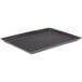 A black rectangular polypropylene pizza tray with small holes.