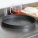 An American Metalcraft hard coat anodized aluminum cake pan on a counter.