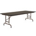 A brown Correll rectangular folding table with a black melamine top.