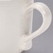A white stoneware mug with a brown rim and handle.