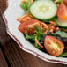 A 10 Strawberry Street Oxford cream stoneware salad bowl filled with a vegetable salad on a table.