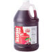 A jug of Carnival King Cherry Slushy Concentrate on a counter.