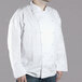 A man wearing a white Chef Revival long sleeve chef coat.