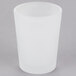 A Sterno frosted votive glass on a gray surface.