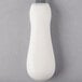A white oyster knife with a textured white plastic handle and a metal tip.
