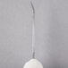 A white textured ball with a silver metal spike.