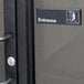 A black and white sign that says "Entrance" on a door.