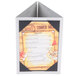 A Menu Solutions brushed aluminum table tent with a menu and picture corners on it.