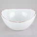 A white melamine bowl with brown trim.