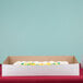 A white full sheet cake box on a table.