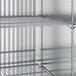 A metal shelf in a True stainless steel reach-in freezer.