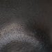 A close up of a black stone surface with light reflections.