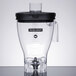 A clear Hamilton Beach blender jar with a black lid.