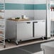 A Beverage-Air stainless steel worktop refrigerator with two doors in a professional kitchen.