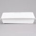 A white paper sandwich clamshell container on a gray surface.