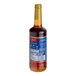 A close up of a Torani Gingerbread Flavoring Syrup bottle with a blue label.