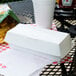 A white take out box on a table.