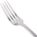A close-up of a Libbey stainless steel dinner fork with a silver handle.