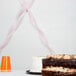 Classic pink streamer paper on a table with a cake and cup.