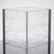 A clear square acrylic riser with a textured surface.