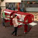 Two women using a Cambro Versa Food/Salad Bar to carry food on trays.