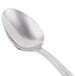 A close-up of a Libbey stainless steel dessert spoon with a silver handle.