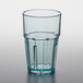 A clear plastic tumbler with a blue rim.