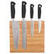 A Mercer Culinary Genesis knife set on a bamboo magnetic board.