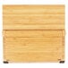 A wooden rectangular Mercer Culinary bamboo knife rack with black magnets.