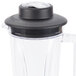 The white lid of an AvaMix blender jar on top of a blender.
