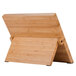 A Mercer Culinary Millennia® bamboo magnetic board with black handles on a wooden stand.