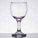 An Anchor Hocking clear wine glass on a white surface.