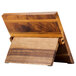 A Mercer Culinary Millennia Acacia Magnetic Board with Red Handle Knives on a wooden table.