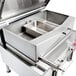 A large stainless steel container with a tilting mechanism inside.