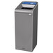 A grey rectangular Rubbermaid recycling container with a blue lid.