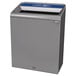 A grey rectangular Rubbermaid recycling container with a blue lid.