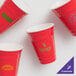 A group of red GET plastic tumblers.