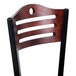 A Lancaster Table & Seating mahogany bistro back rest with wooden slats and holes in it.