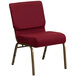 A burgundy church chair with a gold frame.
