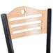A Lancaster Table & Seating natural finish wooden bistro chair back rest with a hole in the back.