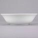 A 10 Strawberry Street Classic White porcelain cereal bowl on a gray surface.